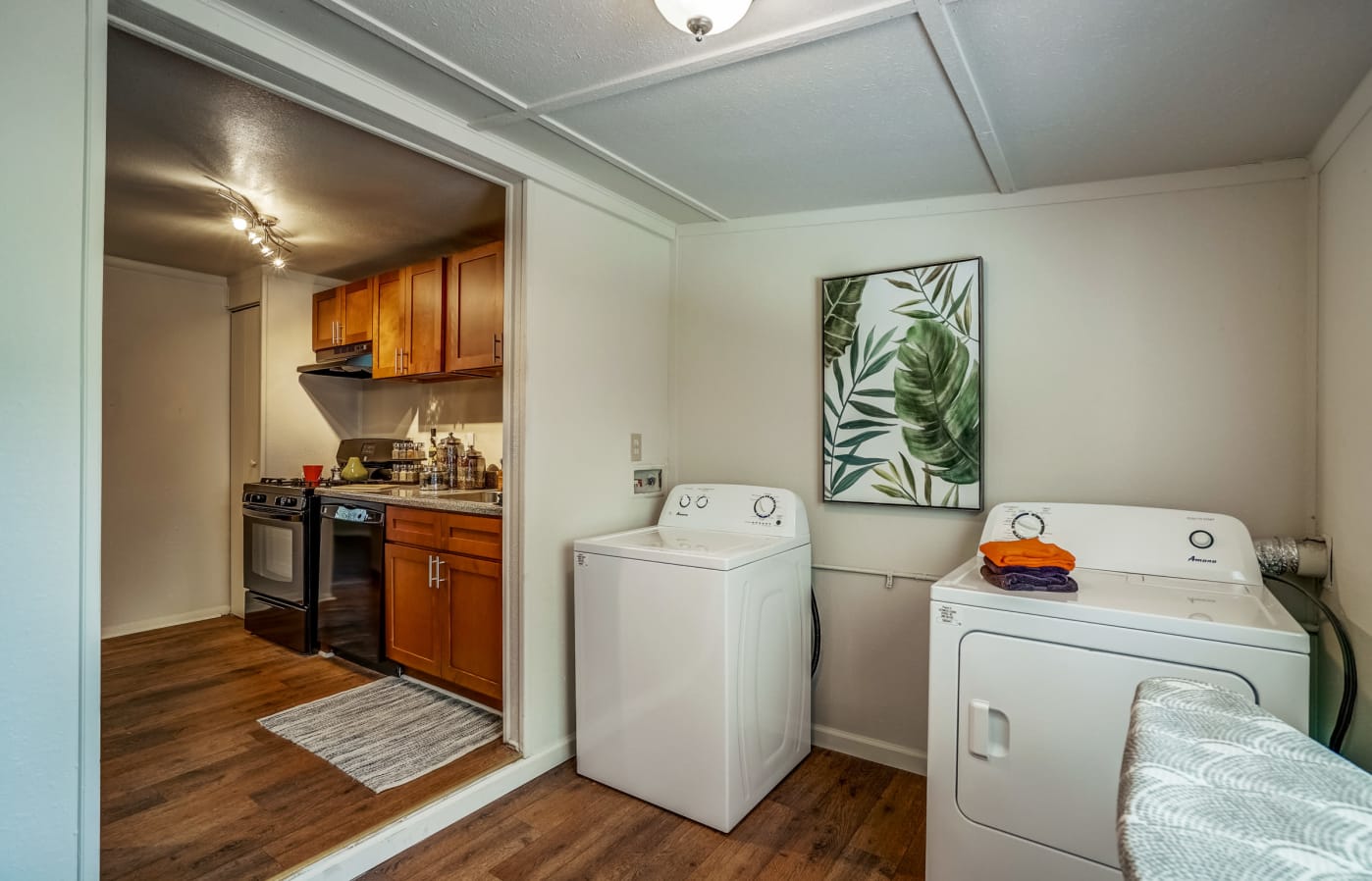 Full-sized washer and dryer in a separate area next to the kitchen
