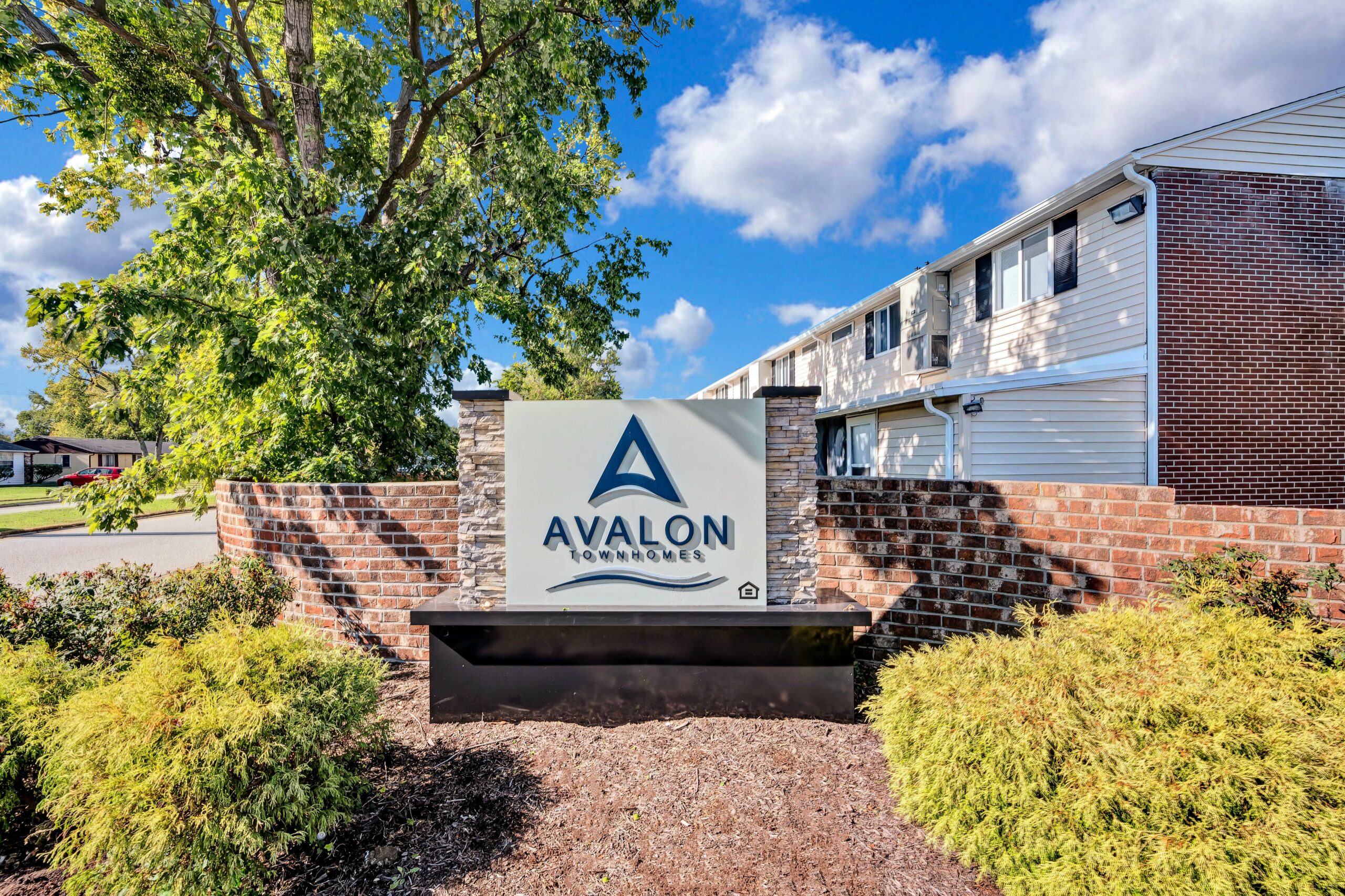 View of Avalon Townhomes sign in front of townhomes